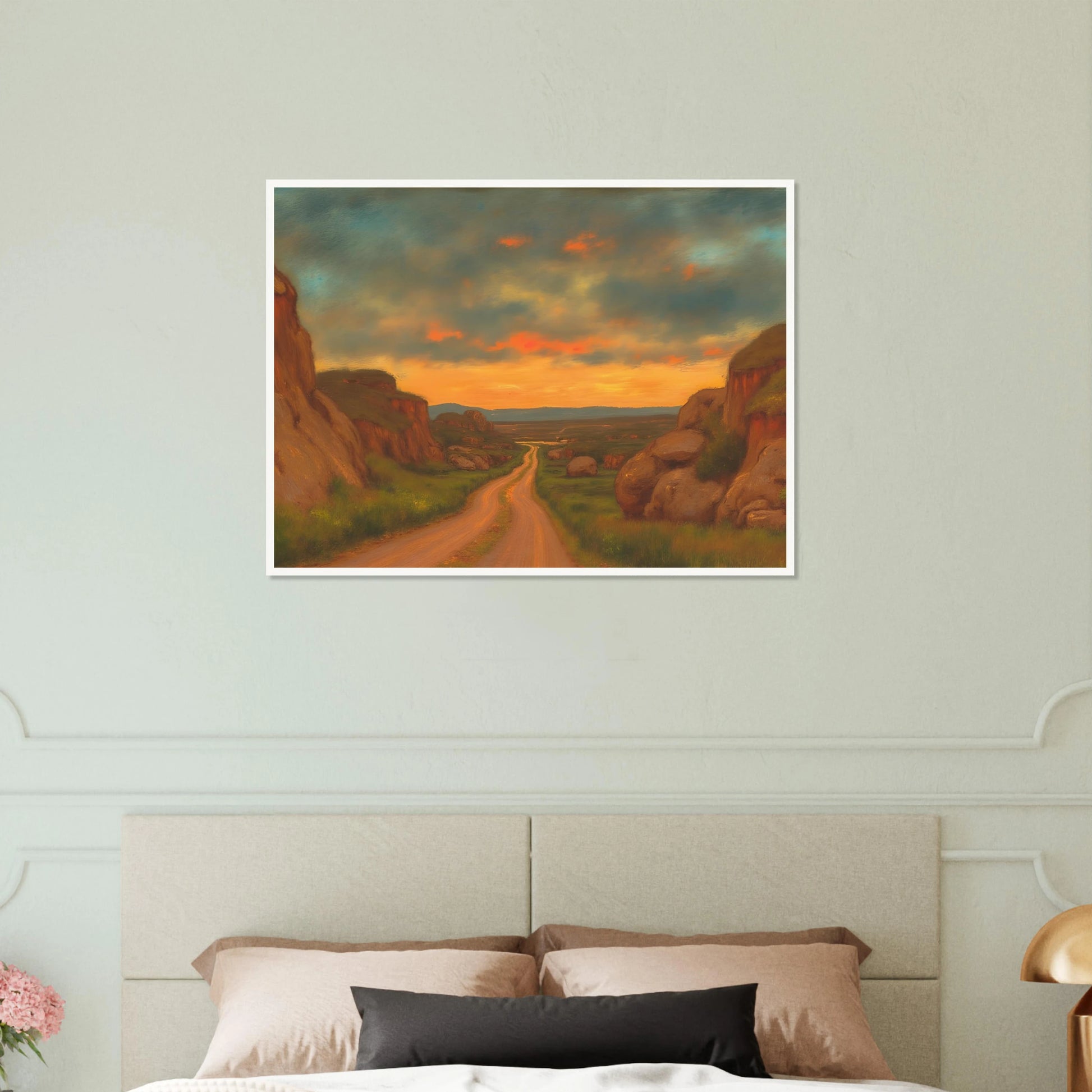A winding dirt road cuts through rocky hills under a glowing sunset sky, evoking peace, wanderlust, and quiet reflection.