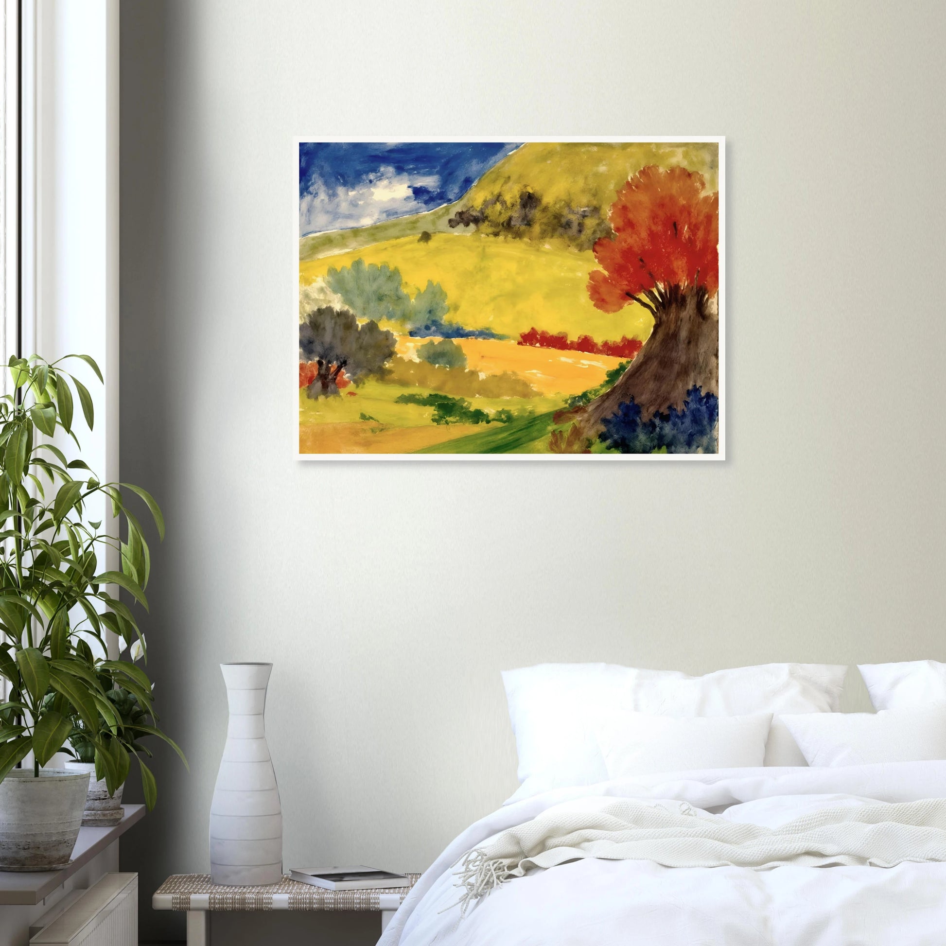 Red tree rises beside golden hills, green fields, and a deep blue sky in a bright countryside scene.