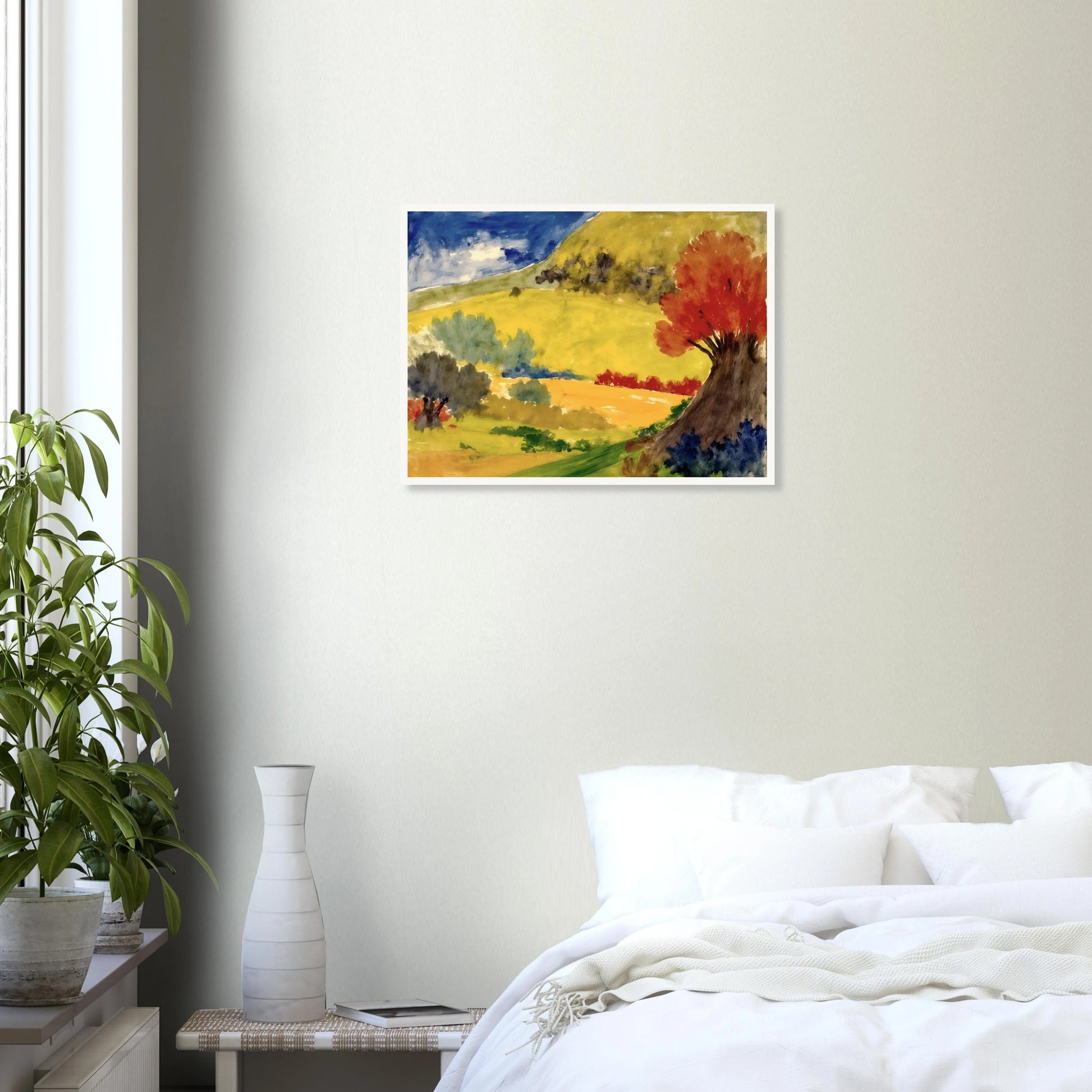 Red tree rises beside golden hills, green fields, and a deep blue sky in a bright countryside scene.