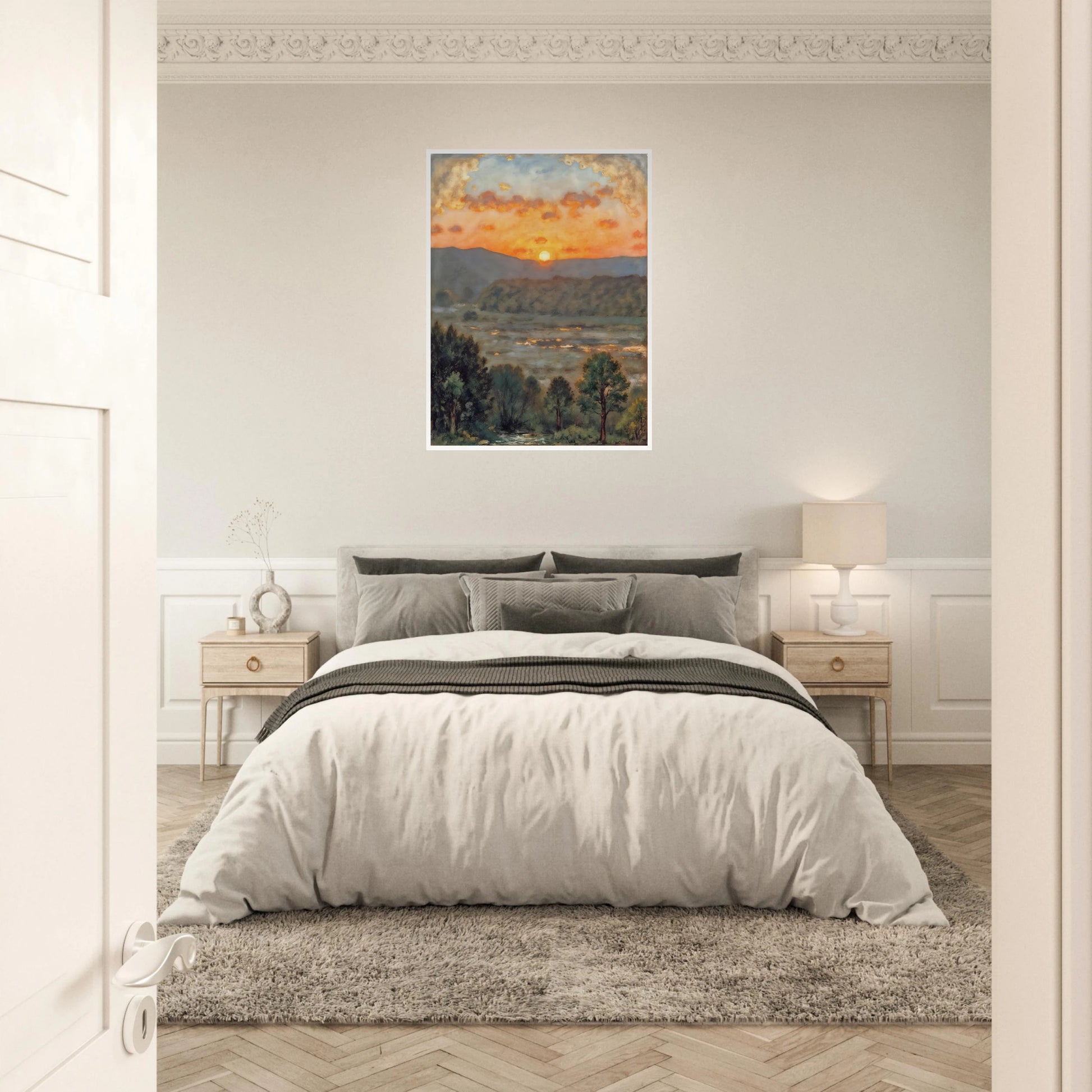 A glowing sunset over misty hills and a river valley, where the sky burns in orange light above soft green trees.