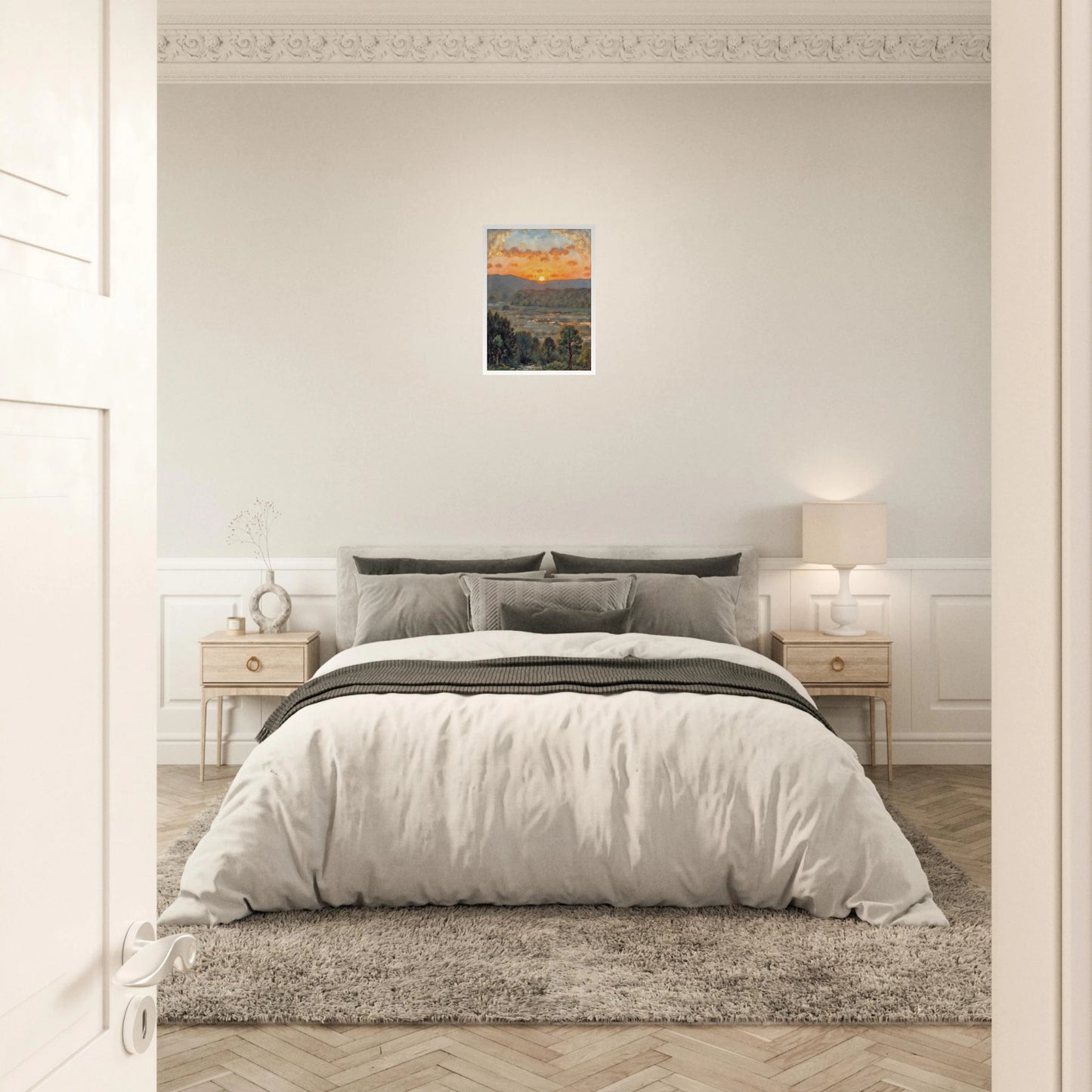 A glowing sunset over misty hills and a river valley, where the sky burns in orange light above soft green trees.