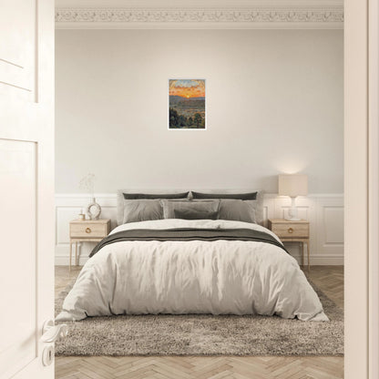 A glowing sunset over misty hills and a river valley, where the sky burns in orange light above soft green trees.