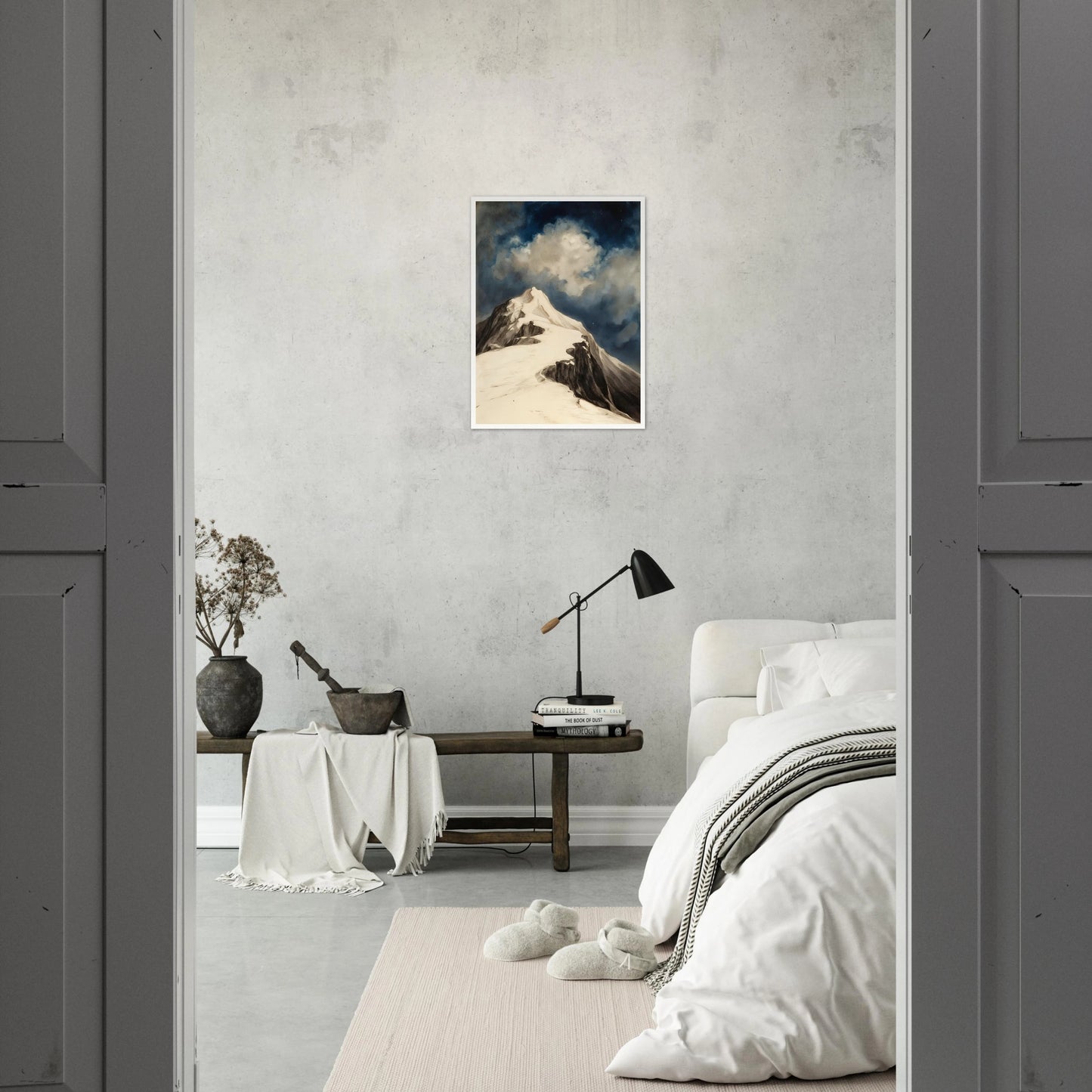 A snow-covered mountain peak rises beneath luminous clouds and a deep midnight sky, capturing solitude and awe.