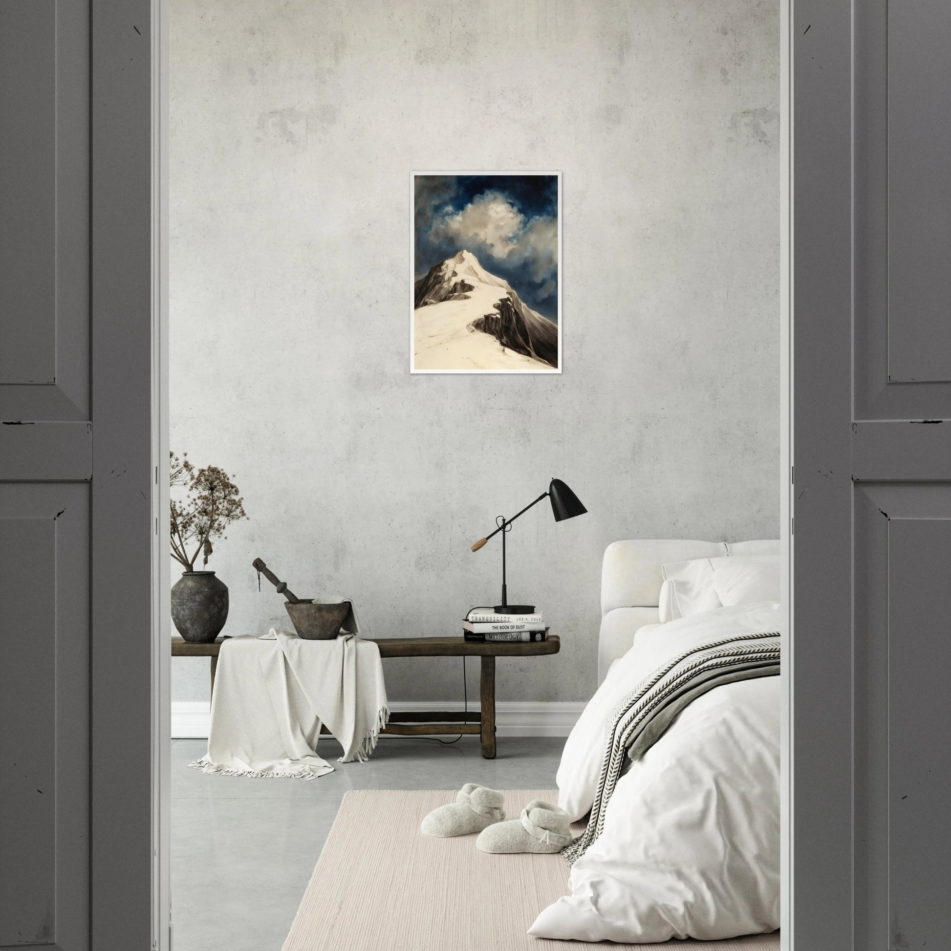 A snow-covered mountain peak rises beneath luminous clouds and a deep midnight sky, capturing solitude and awe.