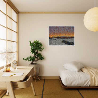 Vibrant orange sunset over distant mountains with textured sky and patterned fields in the foreground.