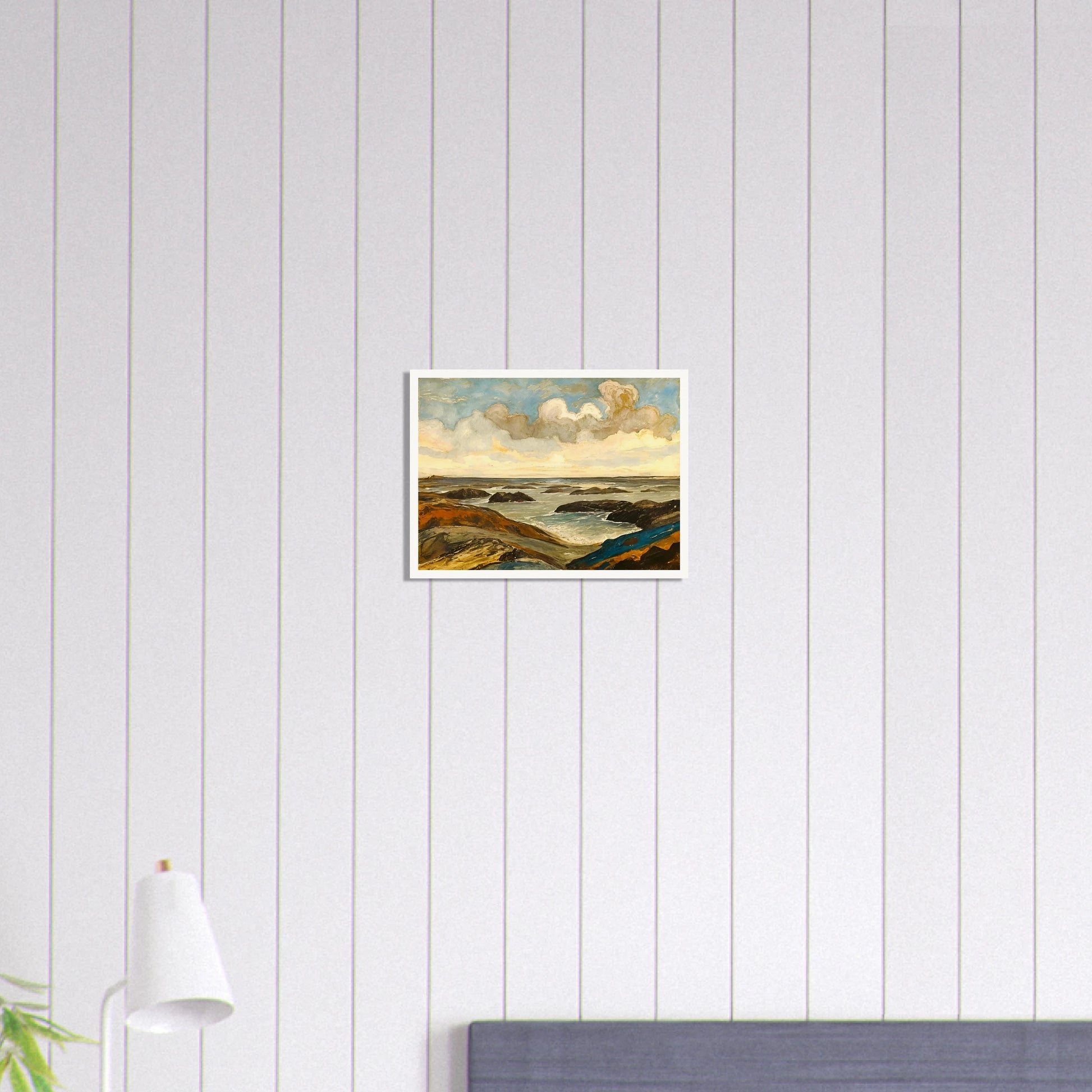 Rocky seashore with dark stones and rolling waves beneath a dramatic sky of shifting clouds and golden sunlight.