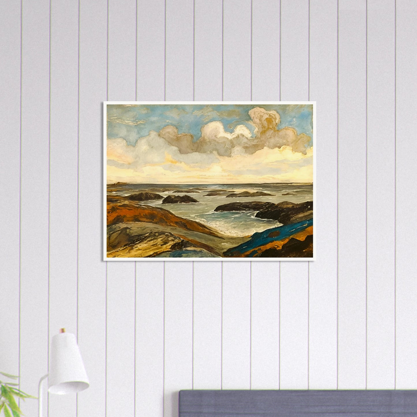 Rocky seashore with dark stones and rolling waves beneath a dramatic sky of shifting clouds and golden sunlight.
