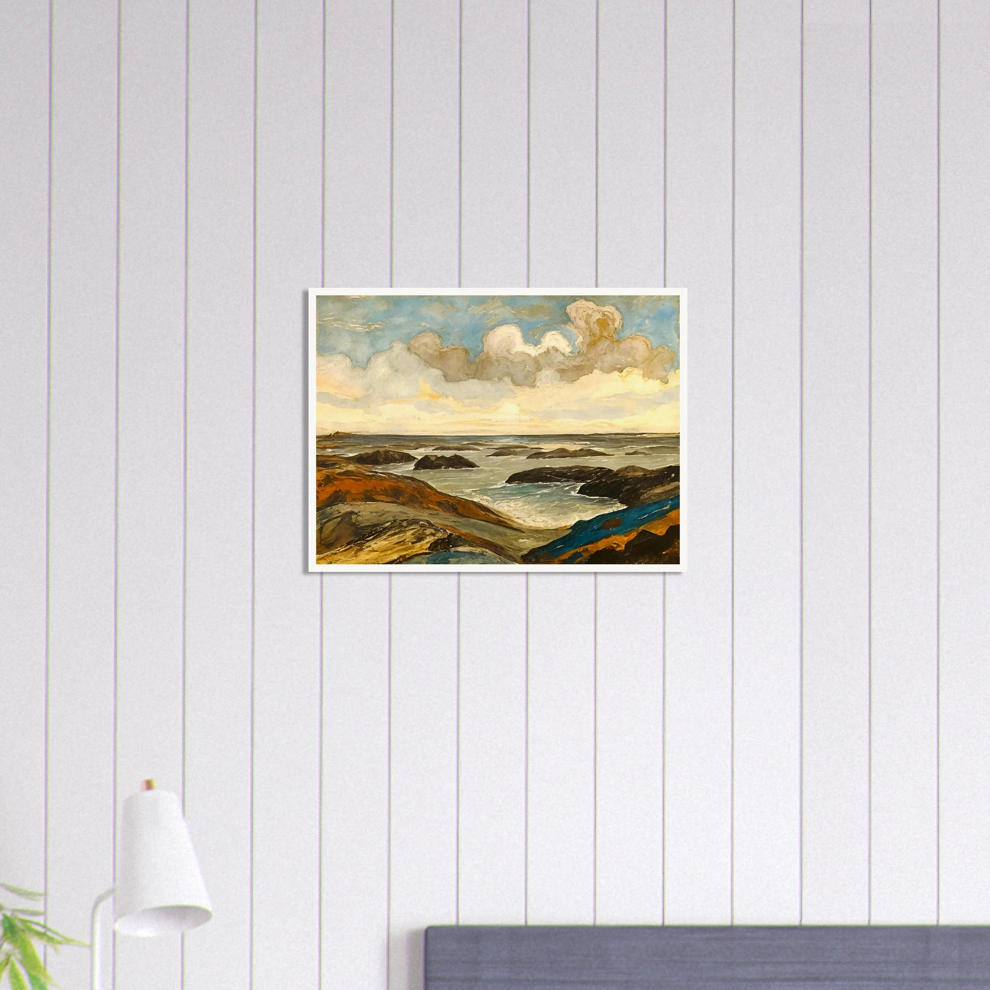 Rocky seashore with dark stones and rolling waves beneath a dramatic sky of shifting clouds and golden sunlight.