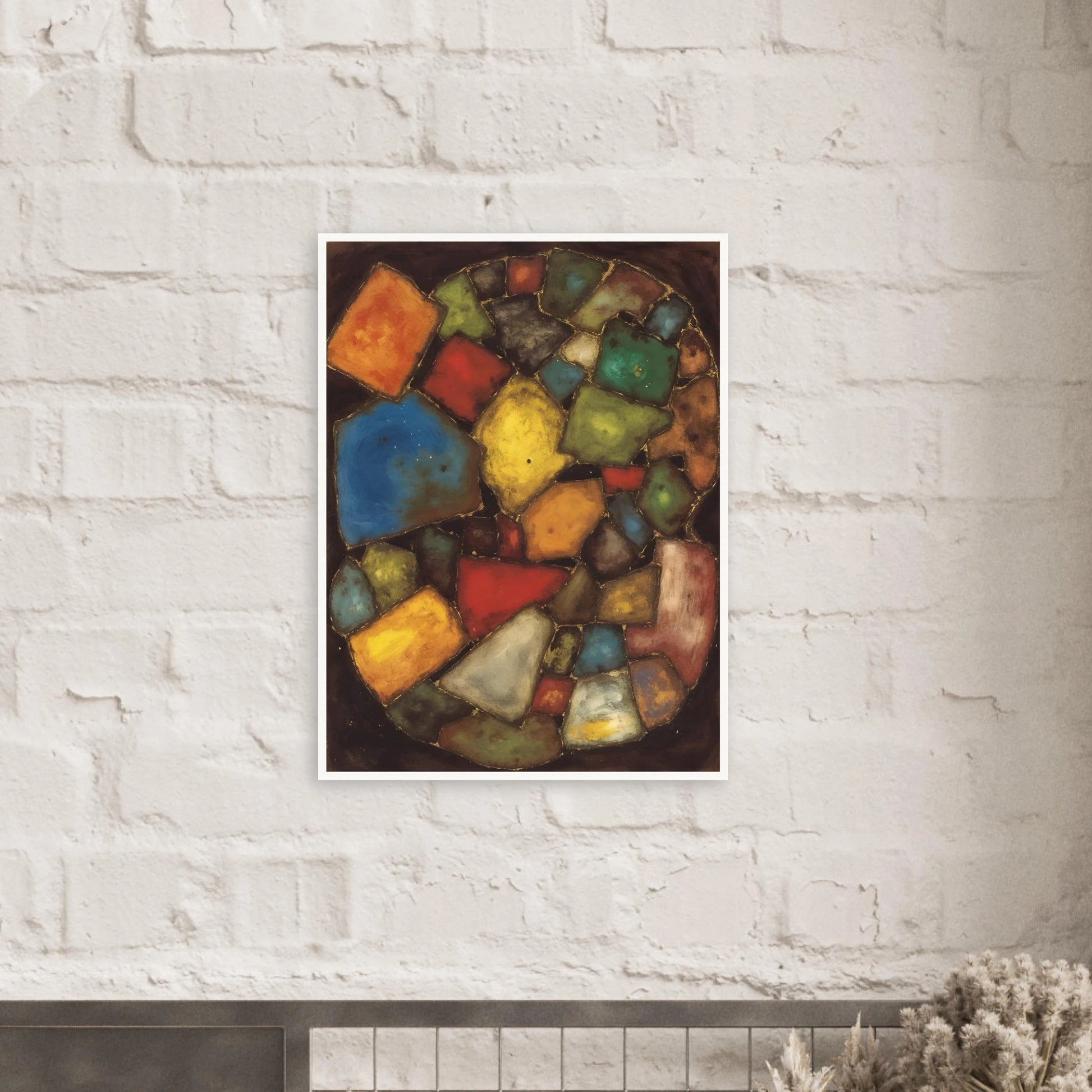 An abstract painting composed of colorful geometric shapes resembling polished stones or stained-glass fragments arranged within an oval composition against a dark background.