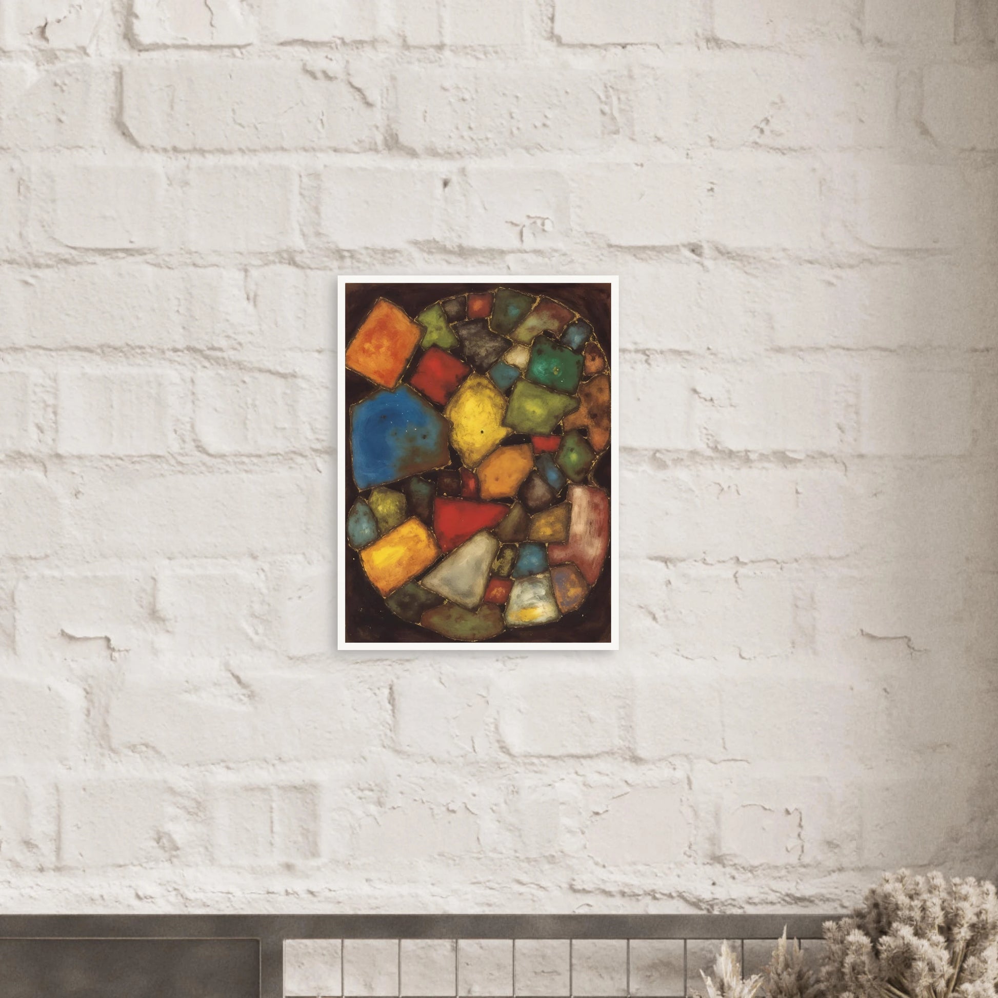 An abstract painting composed of colorful geometric shapes resembling polished stones or stained-glass fragments arranged within an oval composition against a dark background.