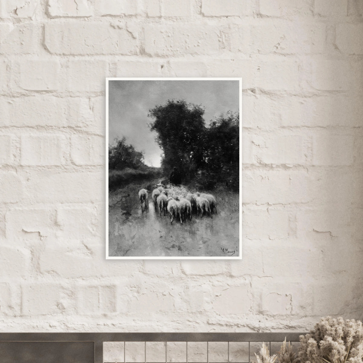 A shepherd leads a flock of sheep along a wooded path beneath tall trees and a cloudy sky.