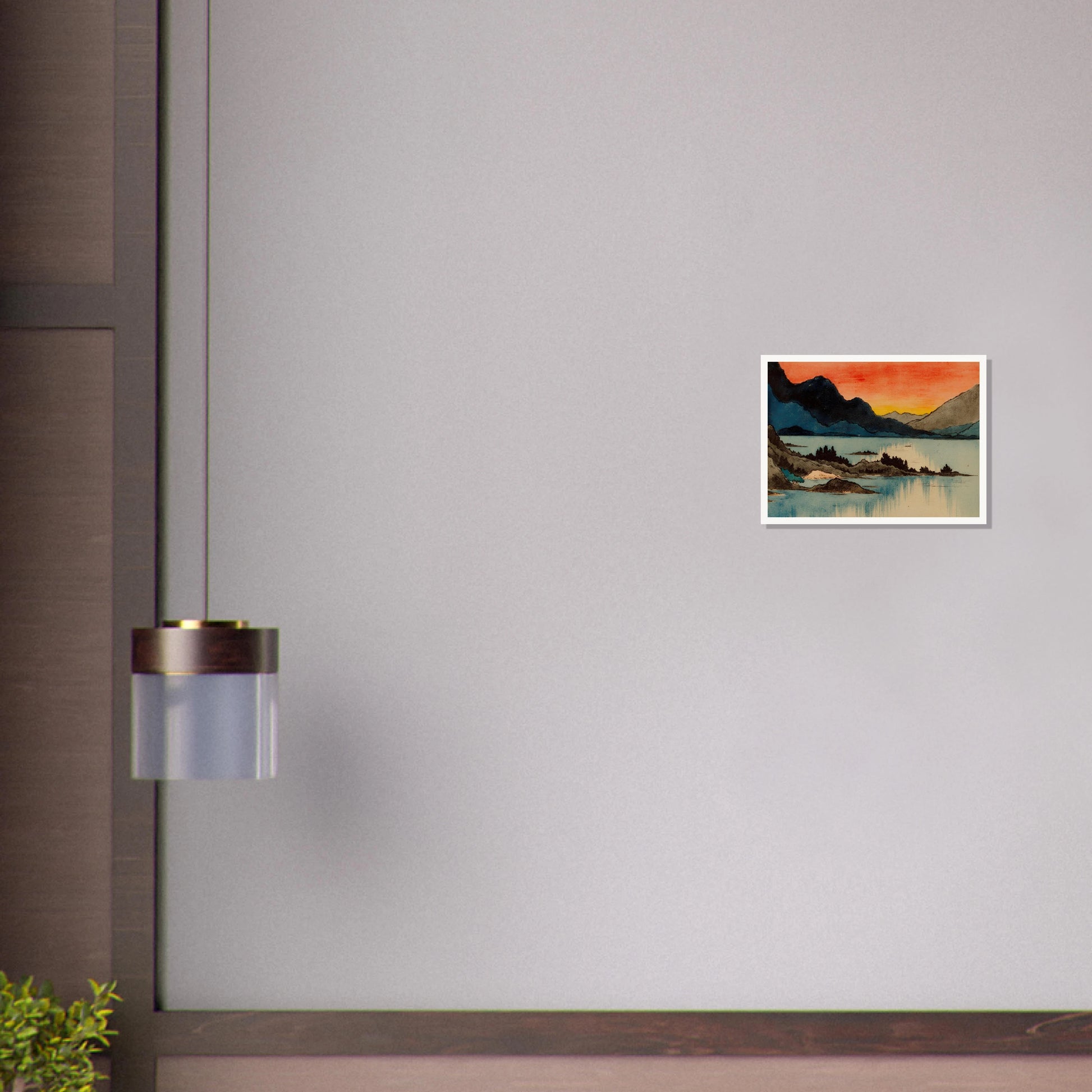 Layered mountain silhouettes meet a glowing red and yellow sunset above calm blue lake waters in a serene scenic view.