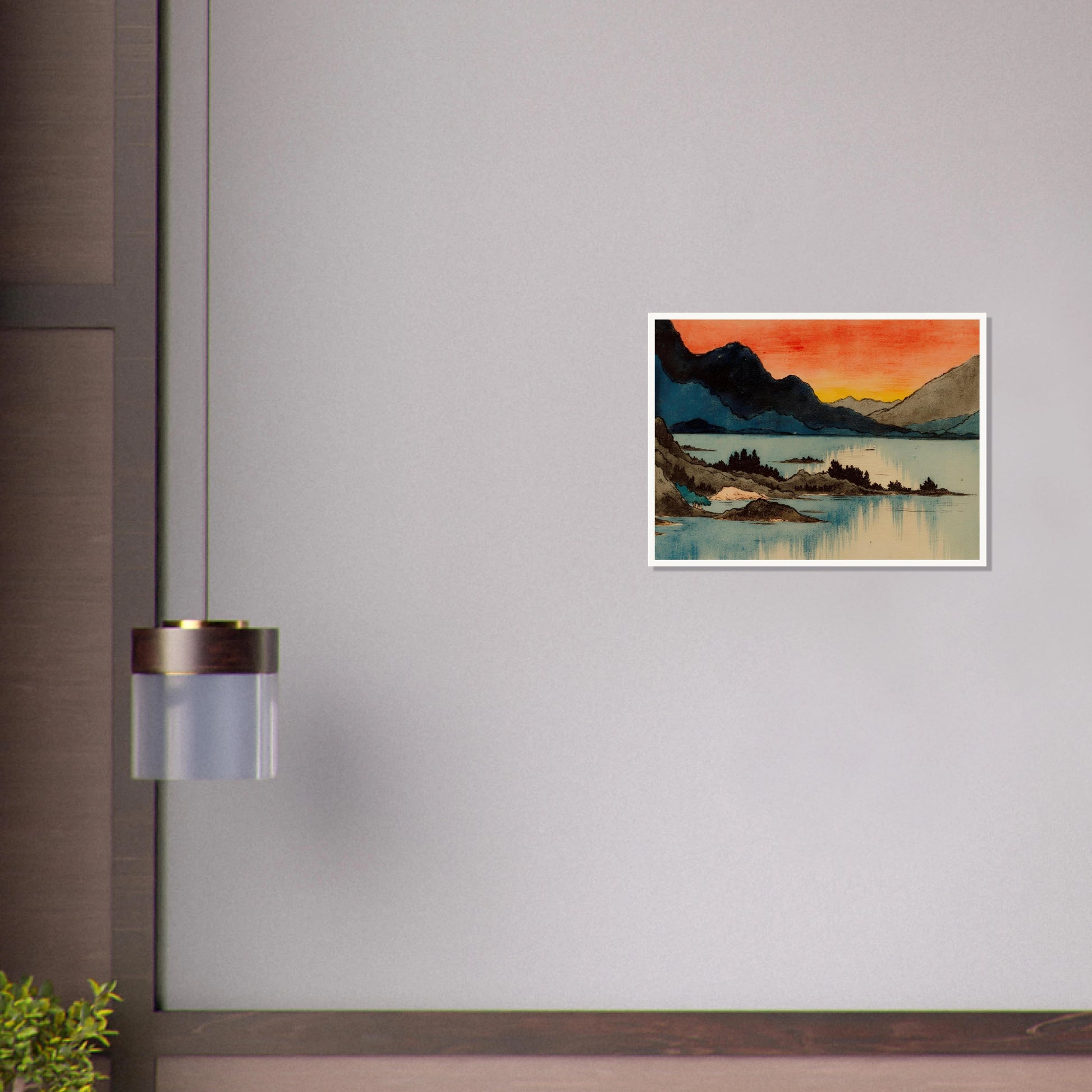 Layered mountain silhouettes meet a glowing red and yellow sunset above calm blue lake waters in a serene scenic view.