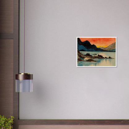 Layered mountain silhouettes meet a glowing red and yellow sunset above calm blue lake waters in a serene scenic view.
