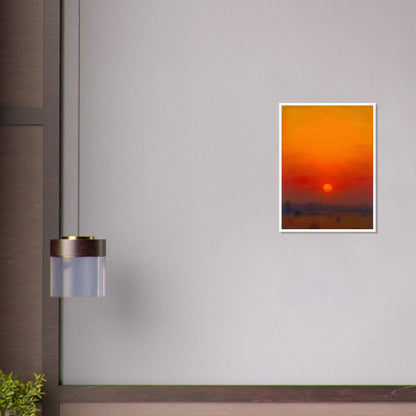 A golden-orange sunset over a hazy horizon, with the sun glowing in a vivid red and amber sky.