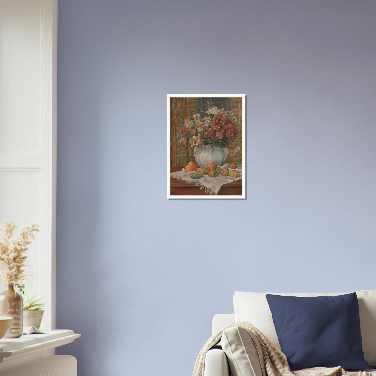 Autumn flowers in a blue vase with prickly pears and cloth on a table before a patterned screen.