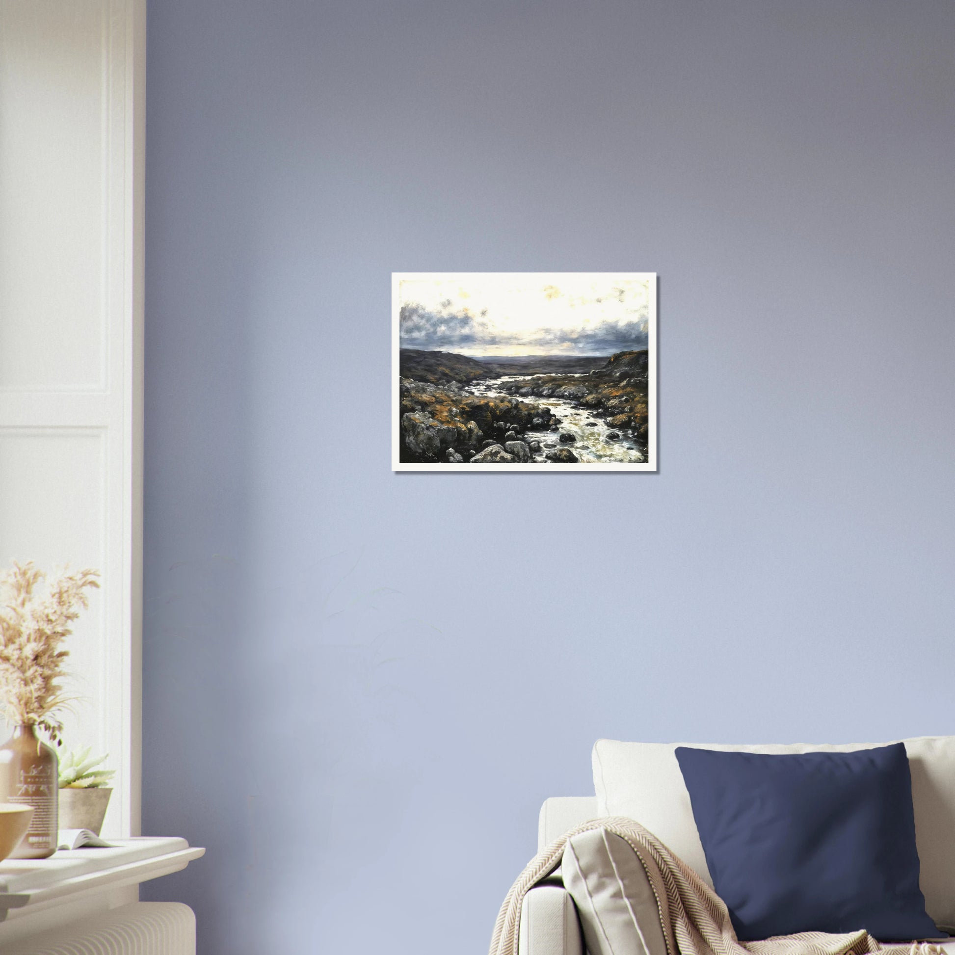A rugged river winds through rocky highlands beneath dramatic clouds, blending silver waters with earthy terrain and distant horizons.