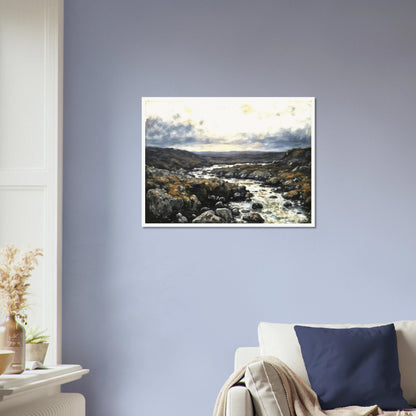 A rugged river winds through rocky highlands beneath dramatic clouds, blending silver waters with earthy terrain and distant horizons.