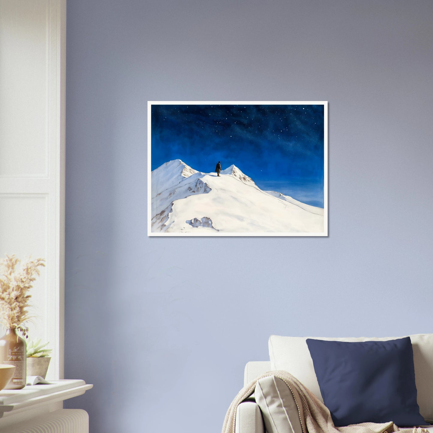 Solitary figure stands atop snowy mountain peaks beneath a vast starlit sky, evoking wonder, silence, and the grandeur of night.