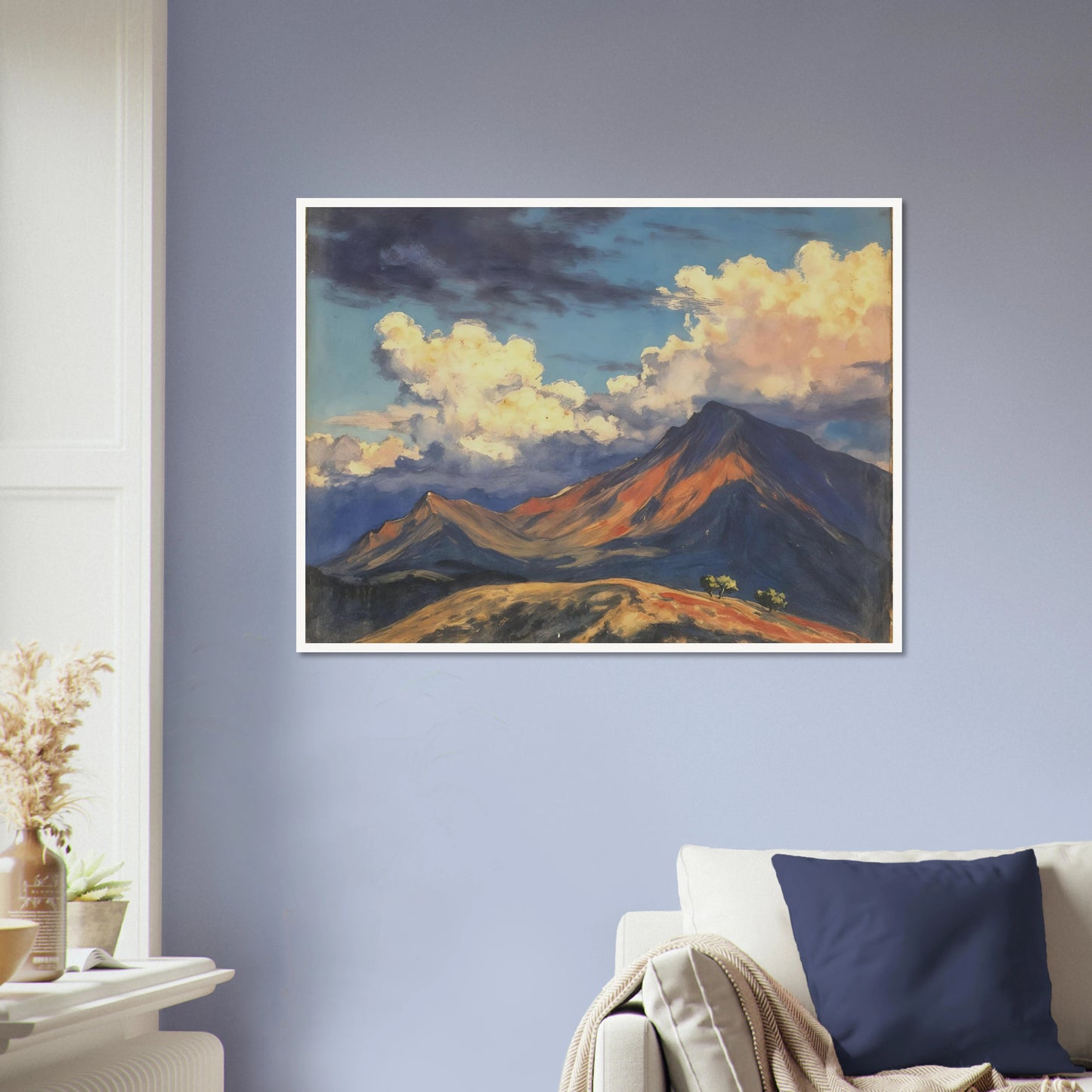 Sunlit mountain peaks glow beneath towering cream clouds and deep blue skies, with warm ridges stretching across an open landscape.
