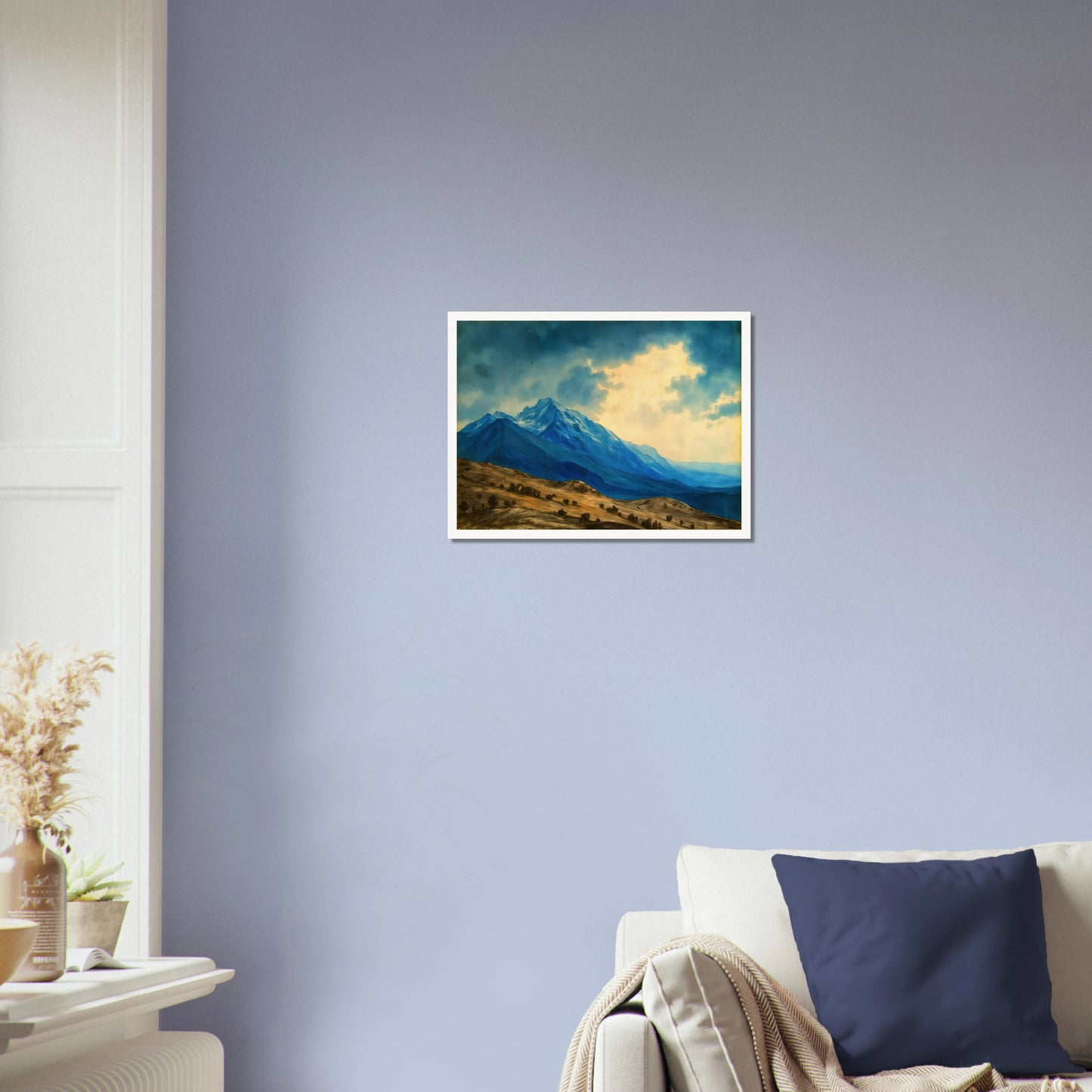 Majestic blue mountain peaks rise above golden rolling plains beneath luminous clouds, blending grandeur, distance, and tranquil wilderness.