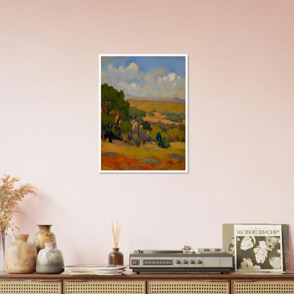 Golden fields and green trees stretch beneath a blue sky with soft clouds and distant hills.