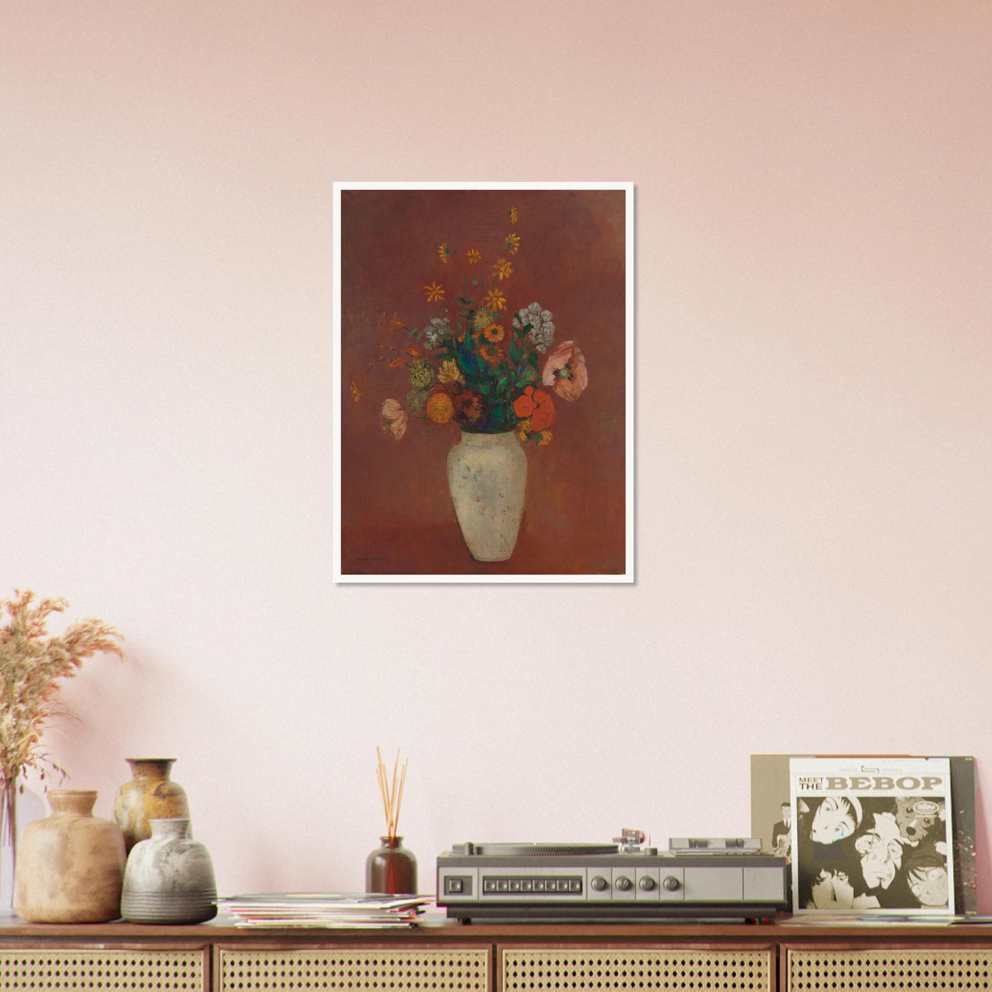 Flowers in a white vase against a red background with yellow and orange blooms