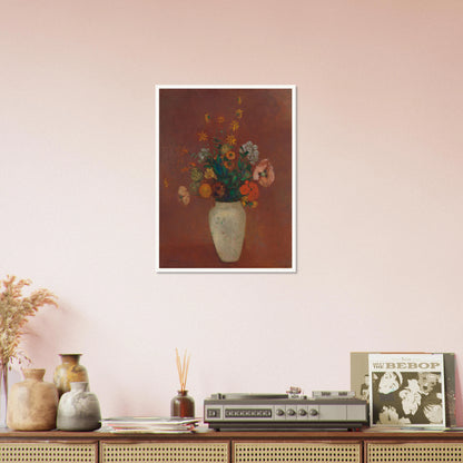 Flowers in a white vase against a red background with yellow and orange blooms