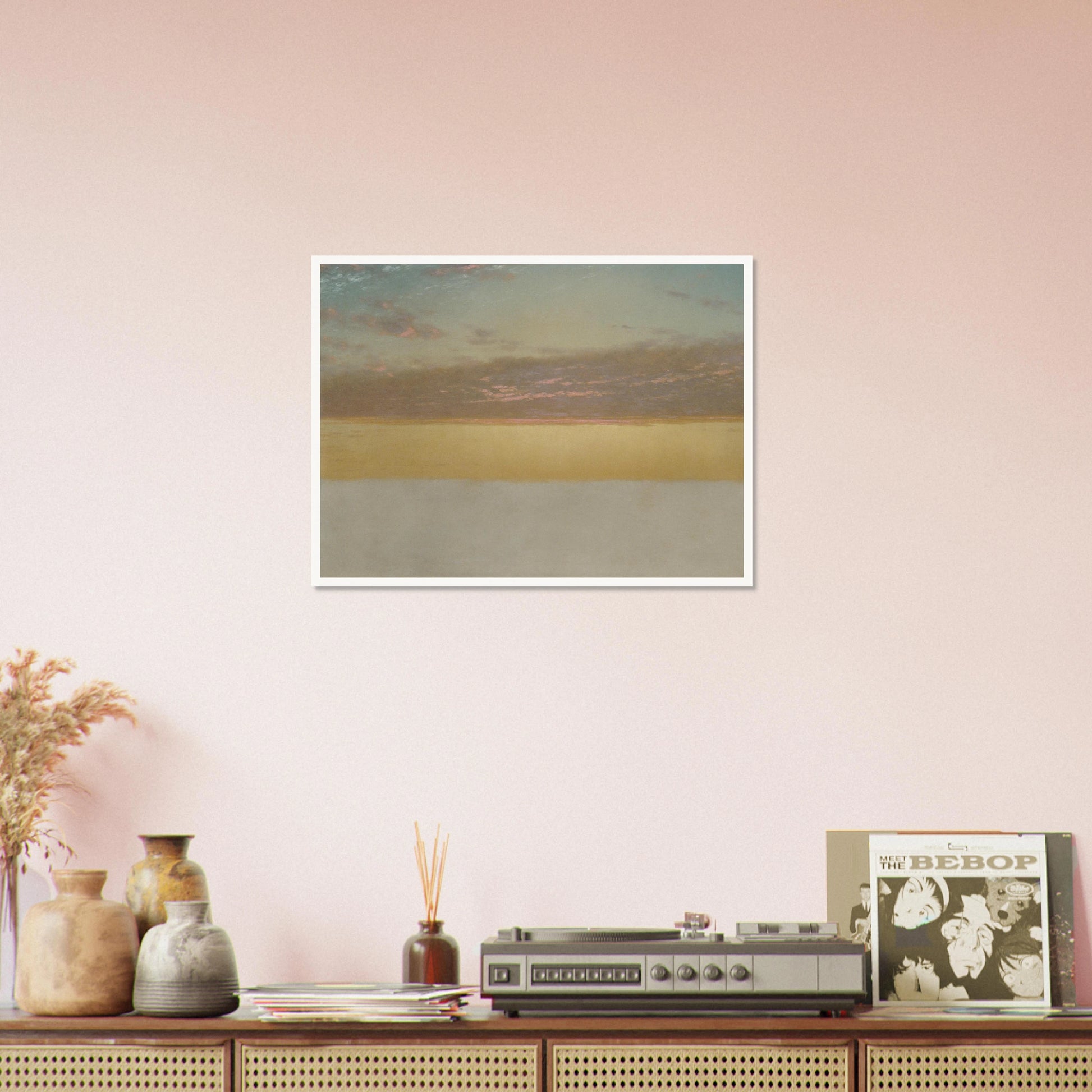 Soft sunset over calm sea with yellow horizon, blue sky, and pink clouds