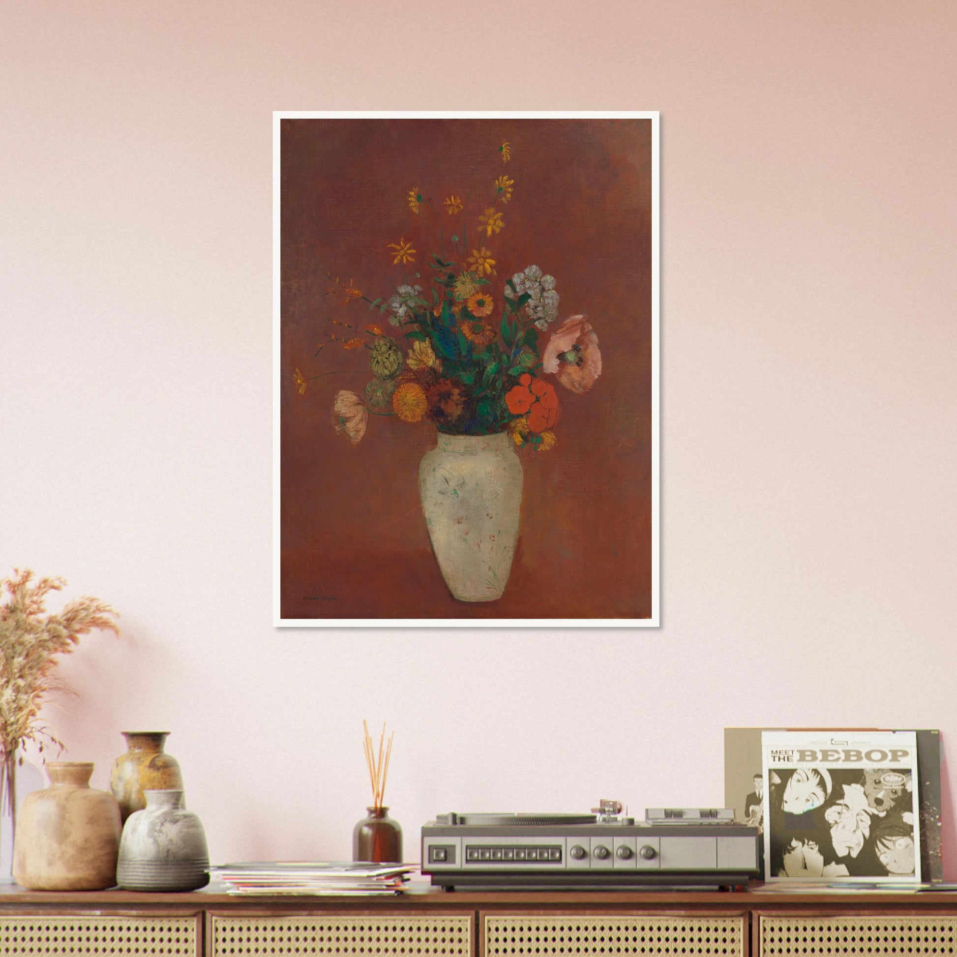 Flowers in a white vase against a red background with yellow and orange blooms