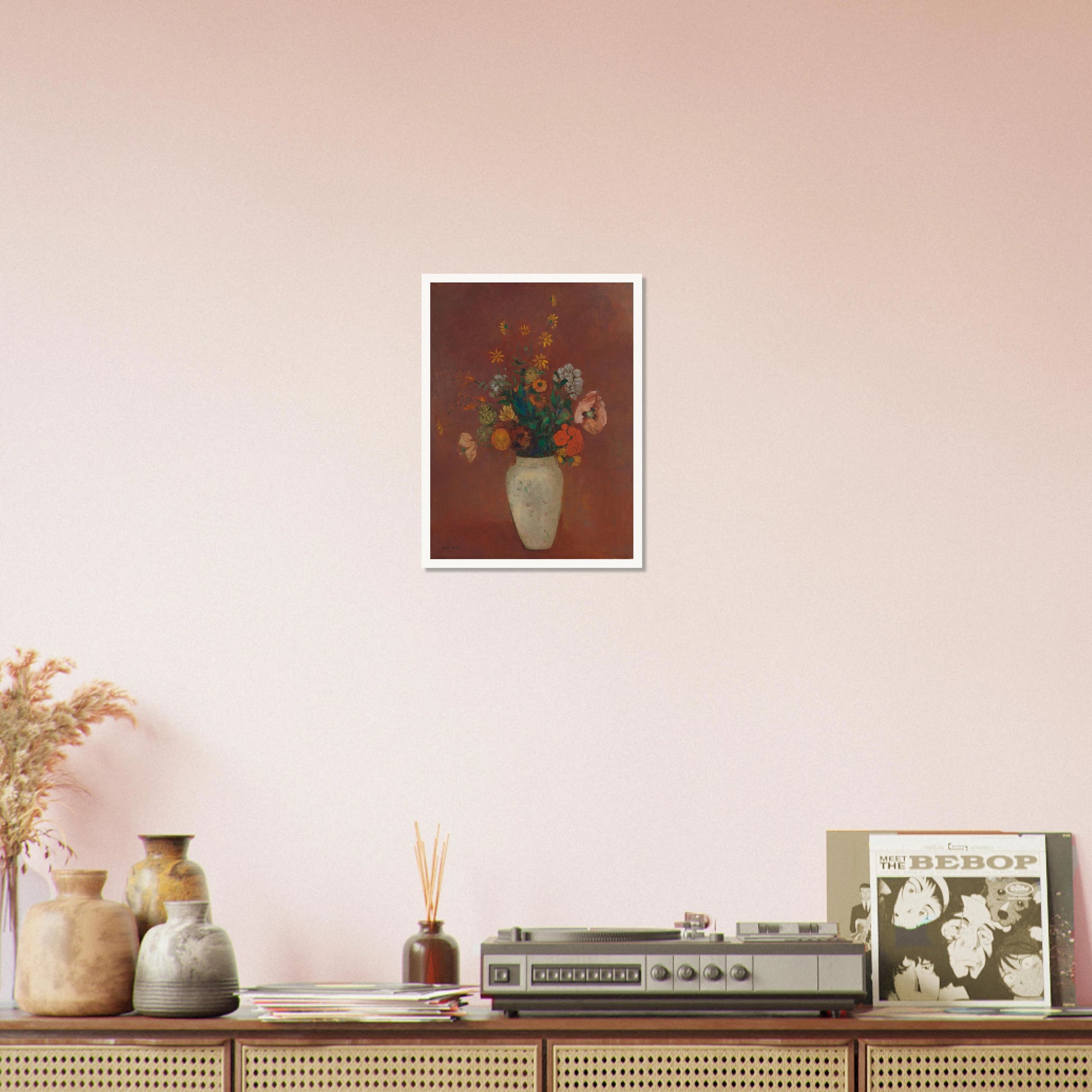 Flowers in a white vase against a red background with yellow and orange blooms