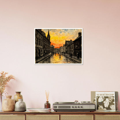 A vintage town street glows beneath a fiery sunset, with wet cobblestones reflecting amber skies and quiet figures walking home.