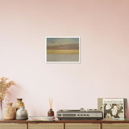 Soft sunset over calm sea with yellow horizon, blue sky, and pink clouds