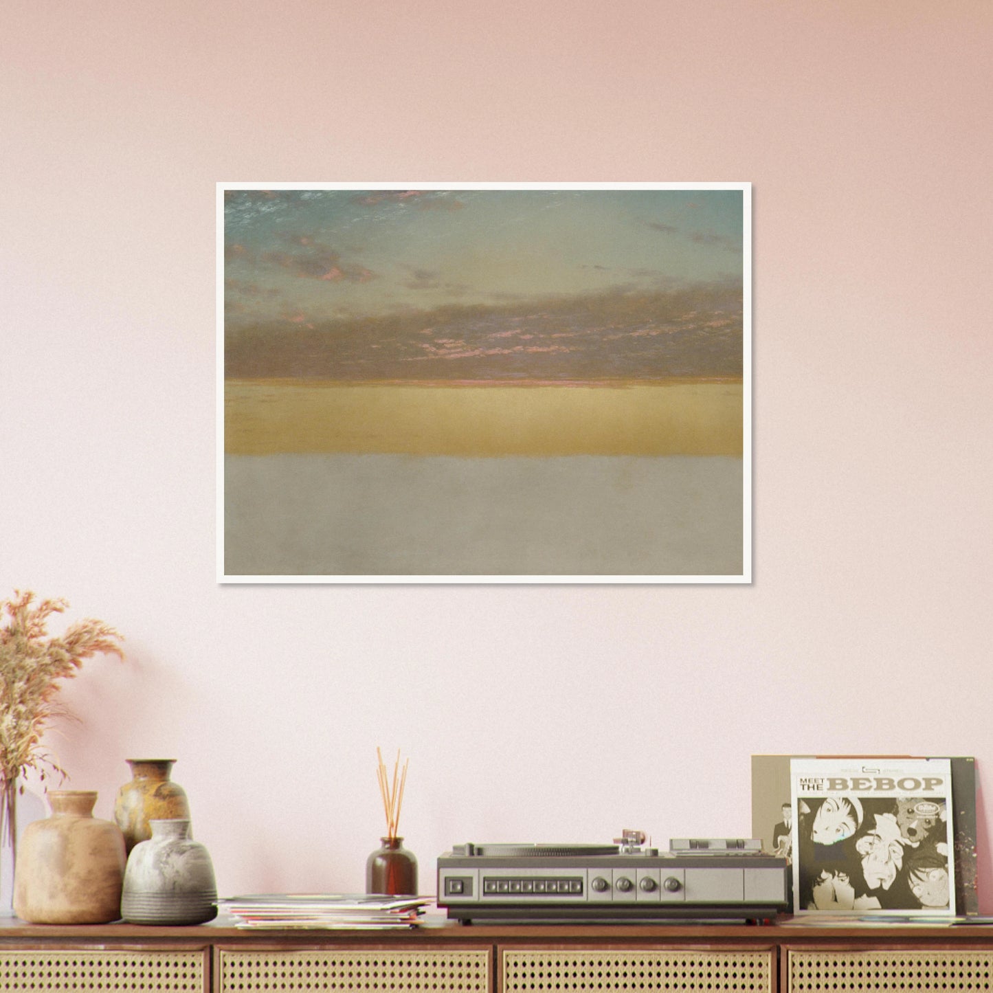 Soft sunset over calm sea with yellow horizon, blue sky, and pink clouds