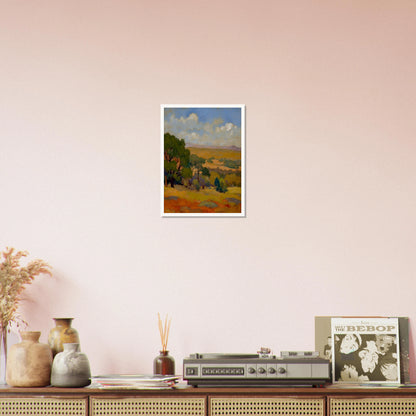 Golden fields and green trees stretch beneath a blue sky with soft clouds and distant hills.