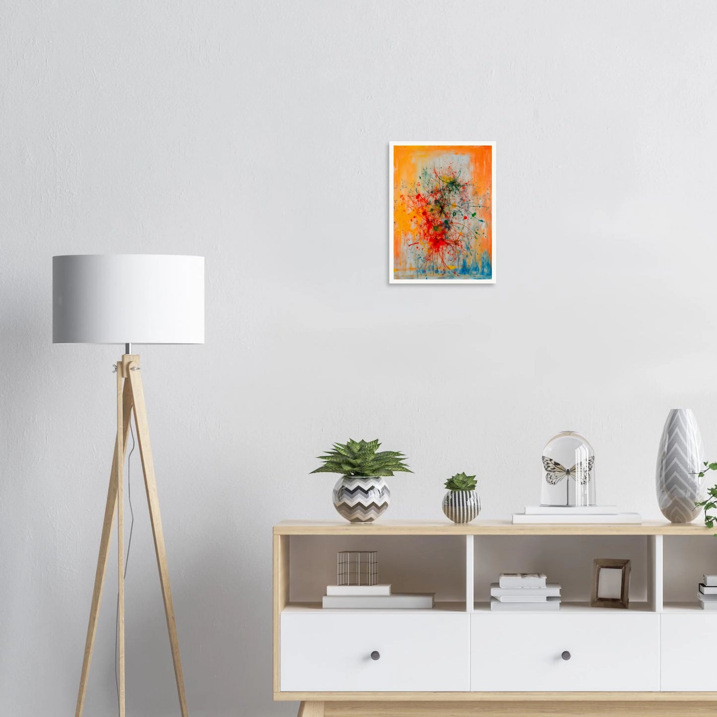 Vivid splashes of red, yellow, blue, and green burst across an orange canvas, evoking movement, chaos, and creative energy.