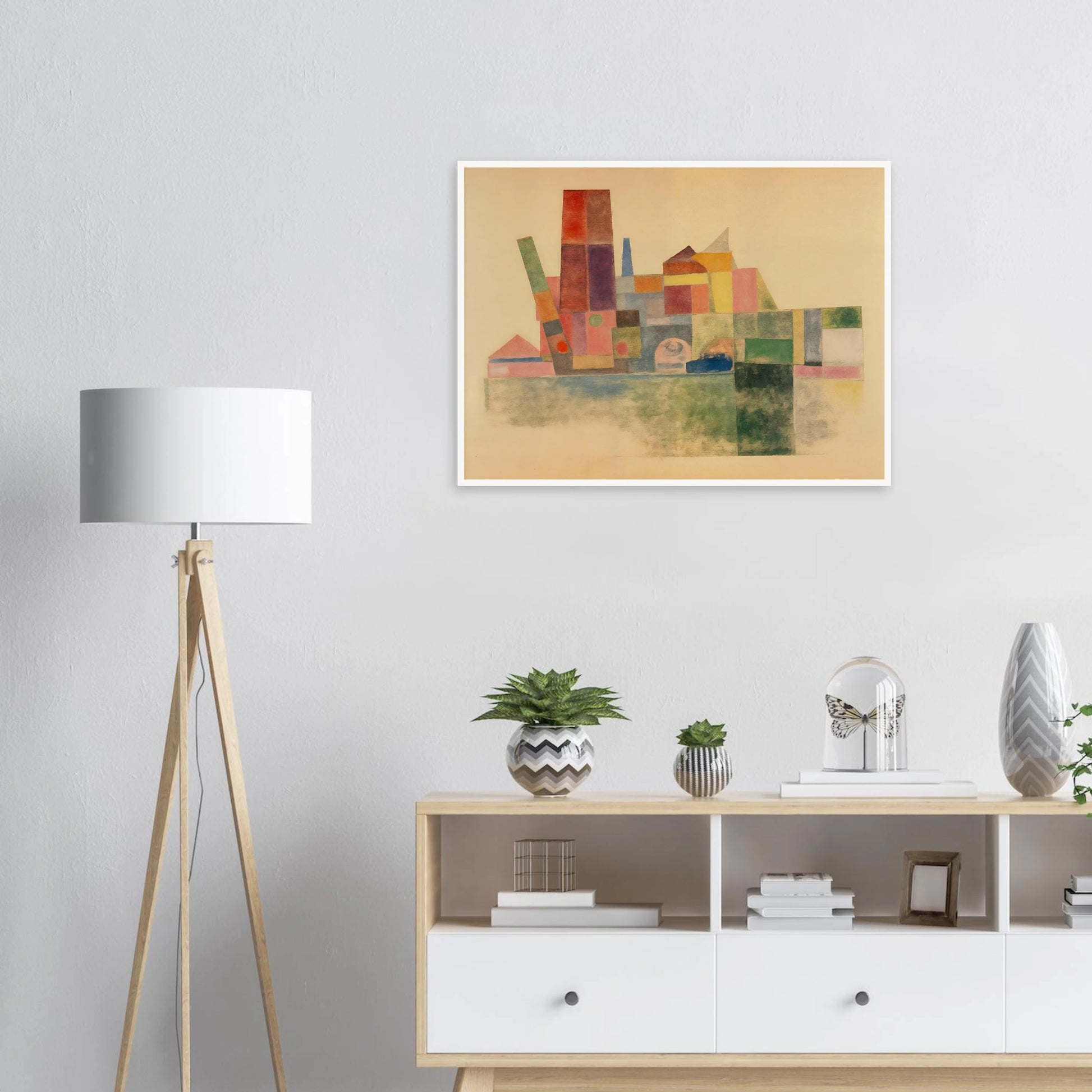 A pastel-toned cityscape made of overlapping geometric blocks in soft reds, greens, yellows, and blues against a beige backdrop.