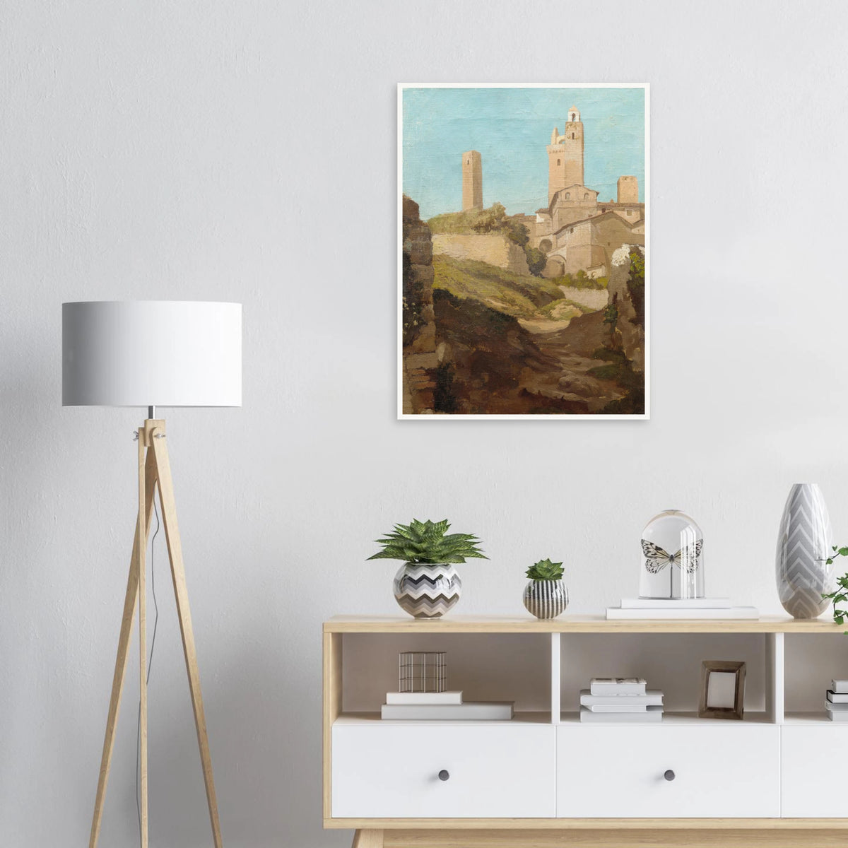 Medieval towers rise above San Gimignano’s sunlit hill town and rough path under a pale blue sky.