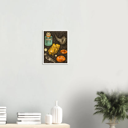 A collection of golden stones, glass objects, and a teal bottle arranged on a textured black background like hidden treasures.