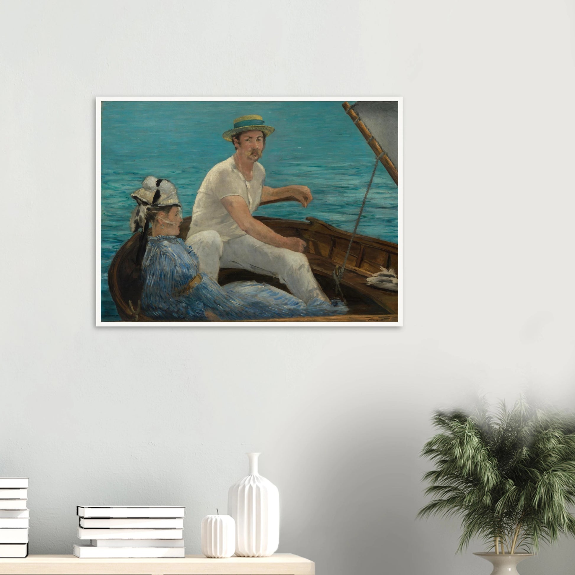 Man and woman sit in a small boat on bright blue water under a gray sail
