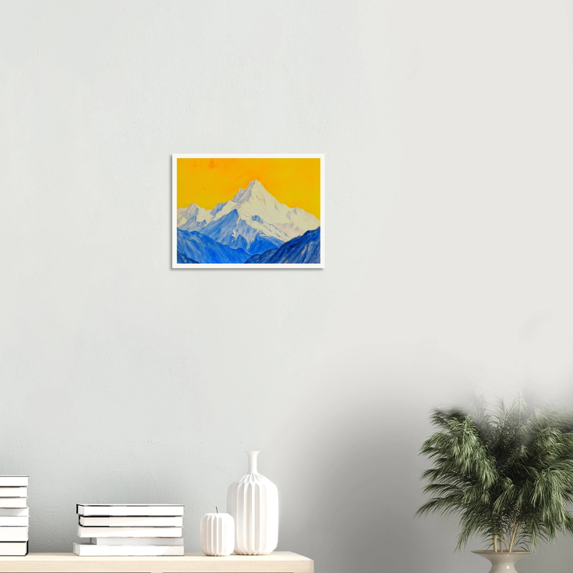 Snowy blue mountain ranges rise beneath a brilliant golden sky, blending icy grandeur with vivid warmth.