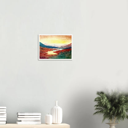 A luminous river winds through crimson hills and distant mountains beneath a glowing sky washed with warm light.