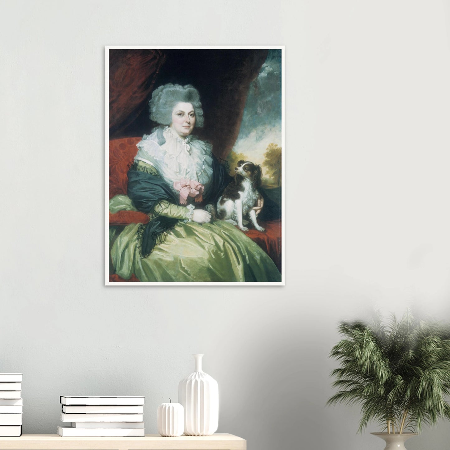 Woman in a green dress sits beside a small black and white dog in a formal portrait