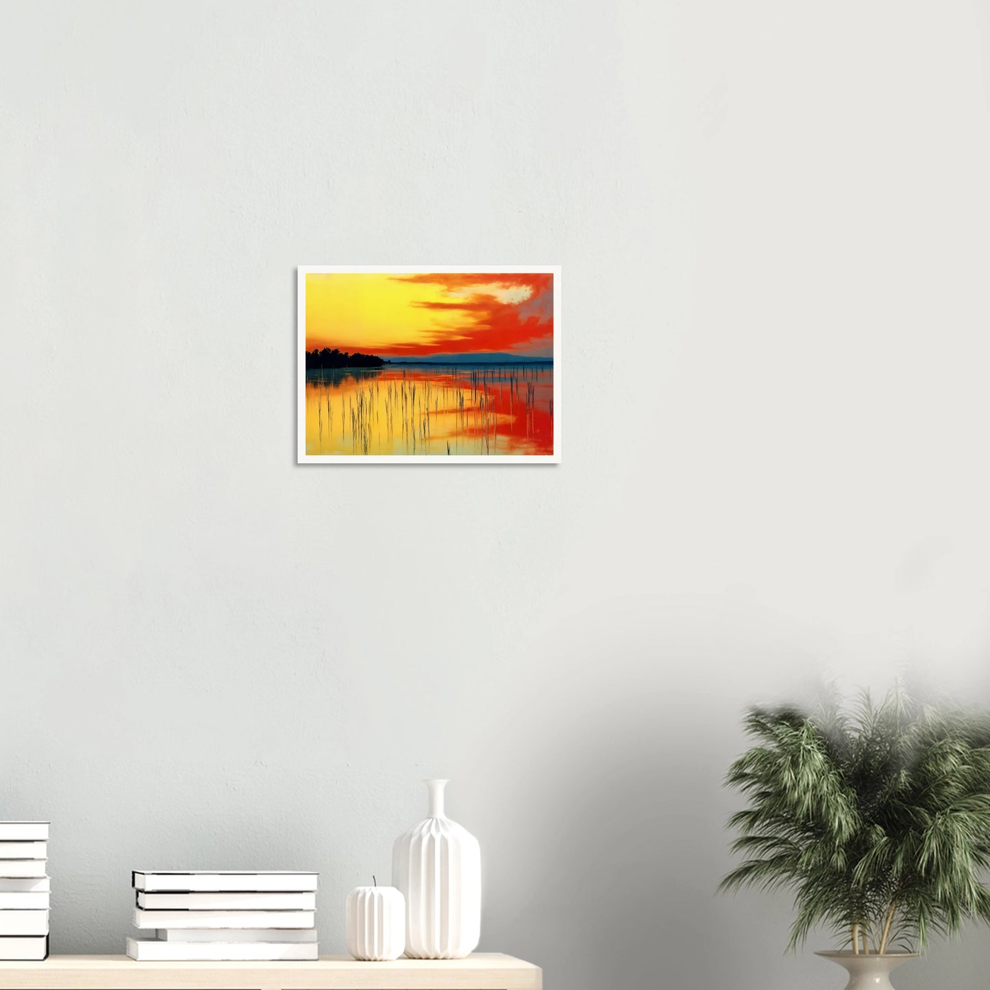 A vivid sunset over calm waters, where orange and yellow hues mirror the sky’s fiery glow and reeds stand in quiet balance.