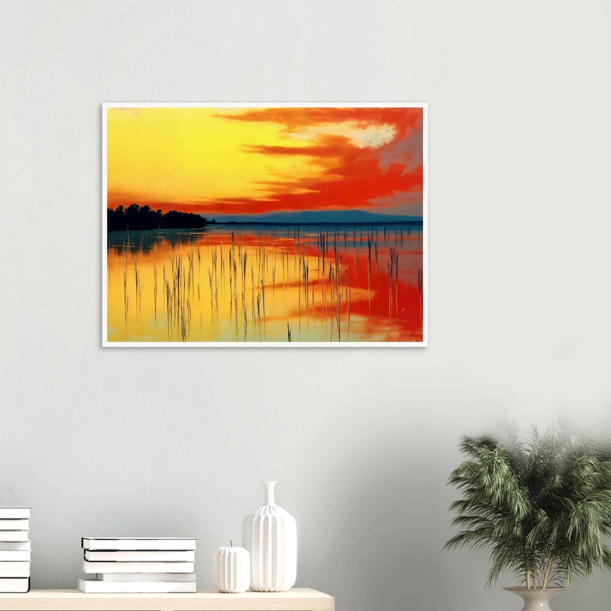 A vivid sunset over calm waters, where orange and yellow hues mirror the sky’s fiery glow and reeds stand in quiet balance.