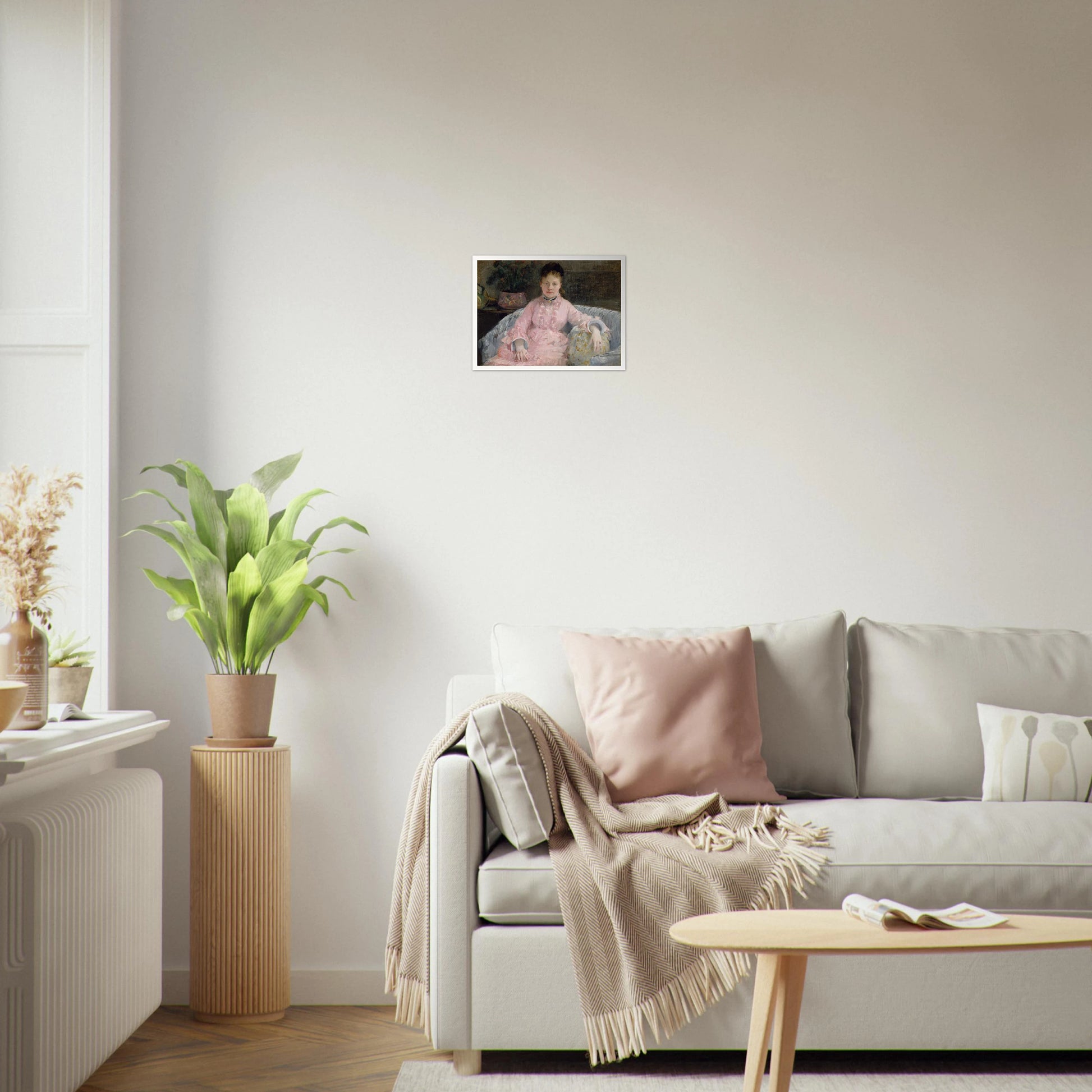 Young woman in a pink dress sits on a sofa beside flowers and a patterned pillow