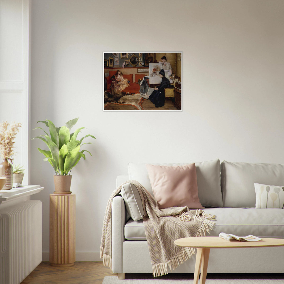 Three women gather in an artist’s studio with an easel, red sofa, framed pictures, and scattered art materials.