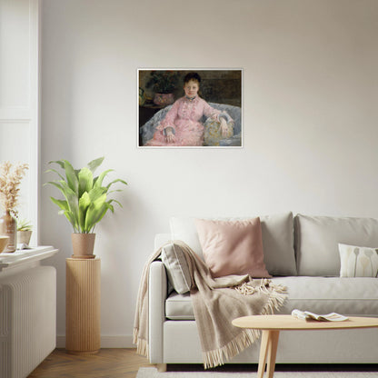 Young woman in a pink dress sits on a sofa beside flowers and a patterned pillow