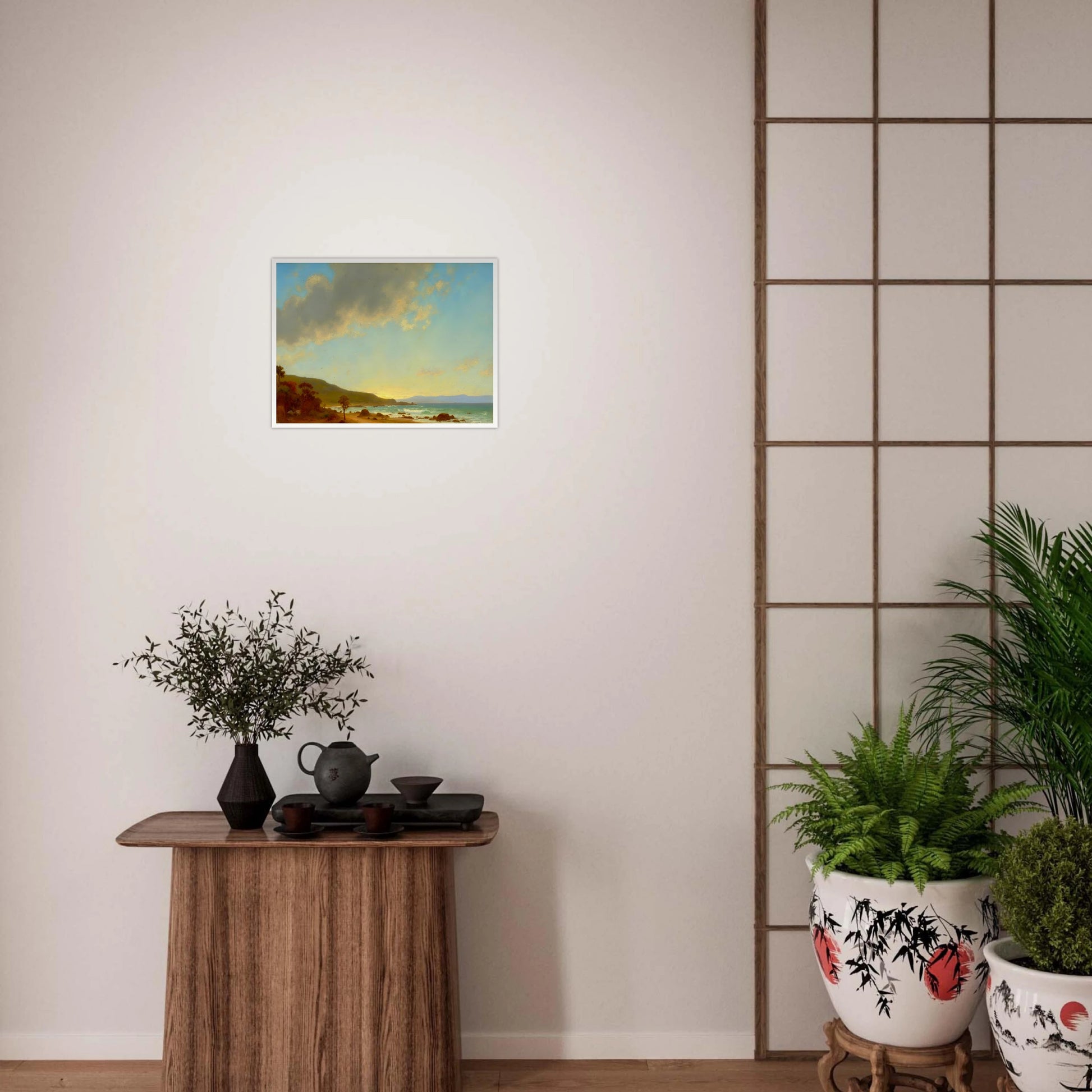 A sunlit coastal landscape with gentle waves meeting a golden shore, framed by rocky outcrops and distant hills under a vast sky.