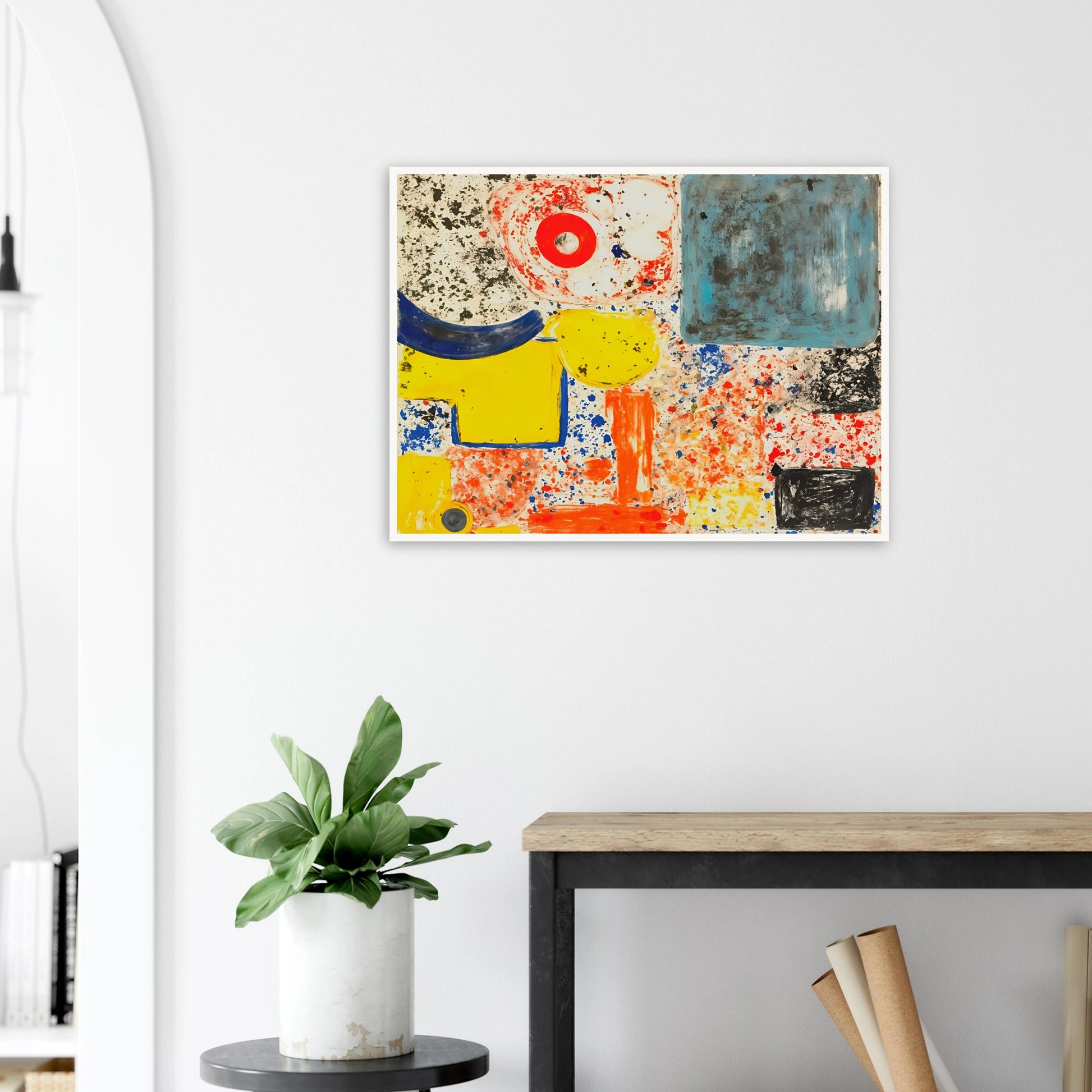 Bright yellow, blue, red, and orange shapes scatter across a speckled white field with bold black marks.